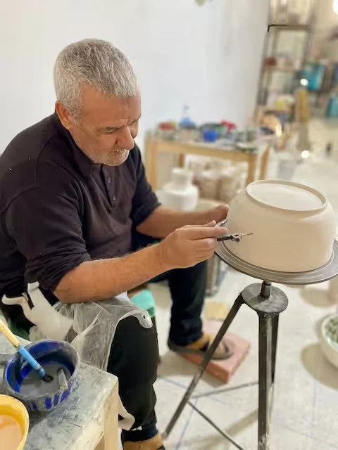 Master potter shaping a bowl on the wheel